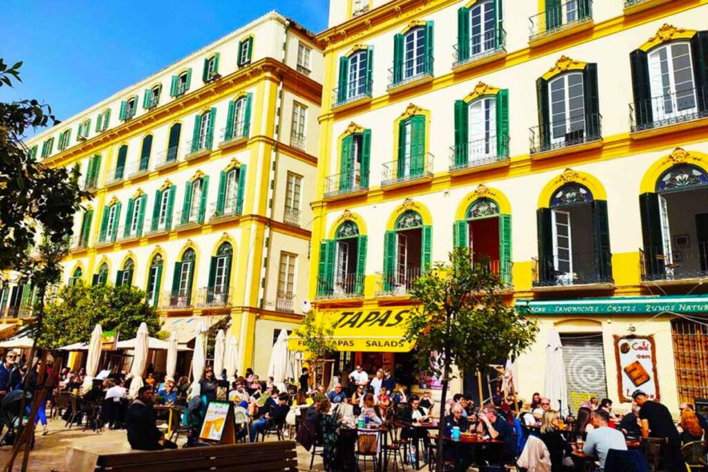 Image of a busy Malaga Centro
with people outside etating in February on a Malaga Winter Break